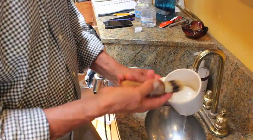 using a traditional shaving mug and brush - creating the lather